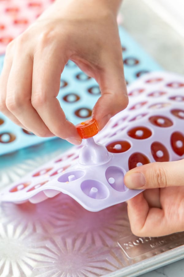 Removing the set gummy candy from the silicone molds.