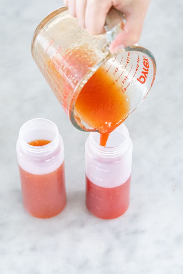 Pouring second half of liquid candy mixture into a second squeeze bottle..
