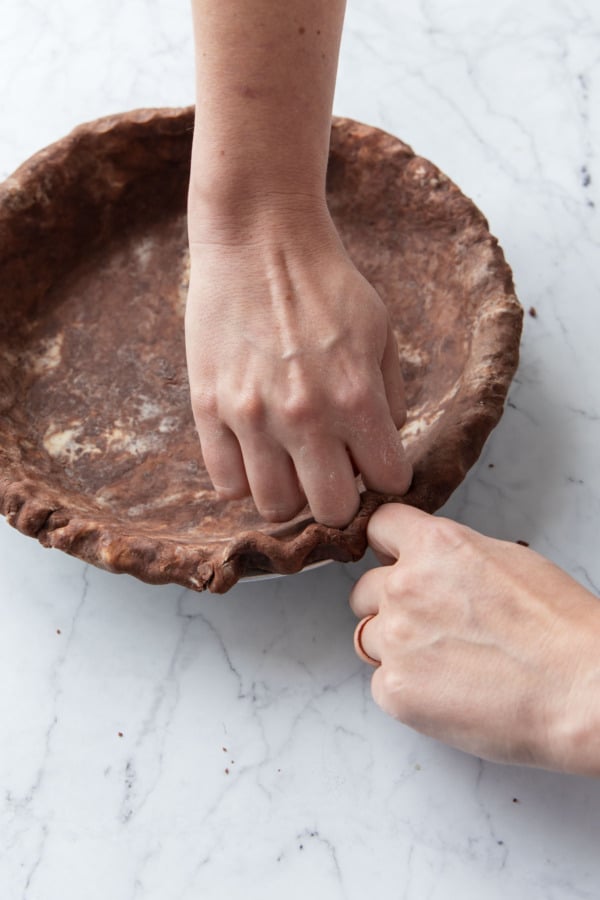 Crimping the crust using 3 knuckles.